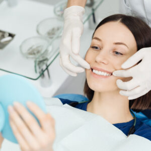 dentist hands and happy patient looking in mirror 2021 12 09 15 05 25 utc (1)