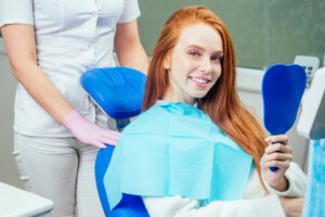 redhaired ginger lady checking teeth in mirror at 2022 05 12 00 51 02 utc