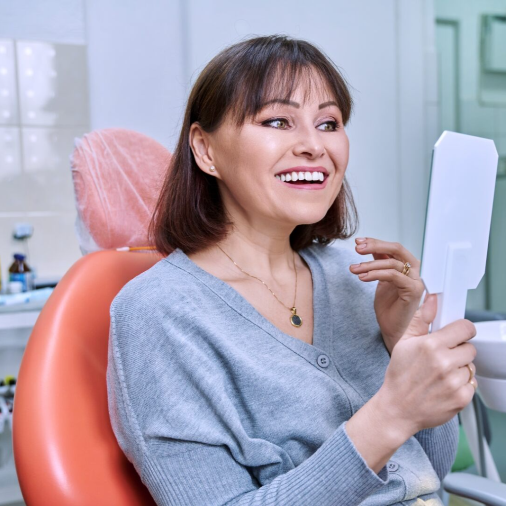 smiling middle aged woman in dental chair with mir 2022 05 25 00 32 58 utc