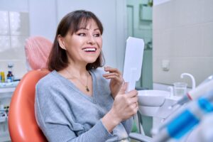 smiling middle aged woman in dental chair with mir 2022 05 25 00 32 58 utc